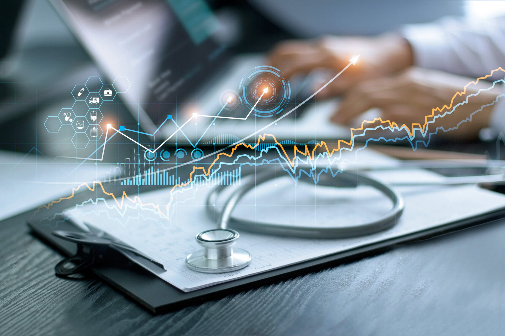 Healthcare business graph data and growth, Stethoscope with doctor's health report clipboard on table, Medical examination and doctor analyzing medical report on laptop screen. Graph on top of Writing Pad