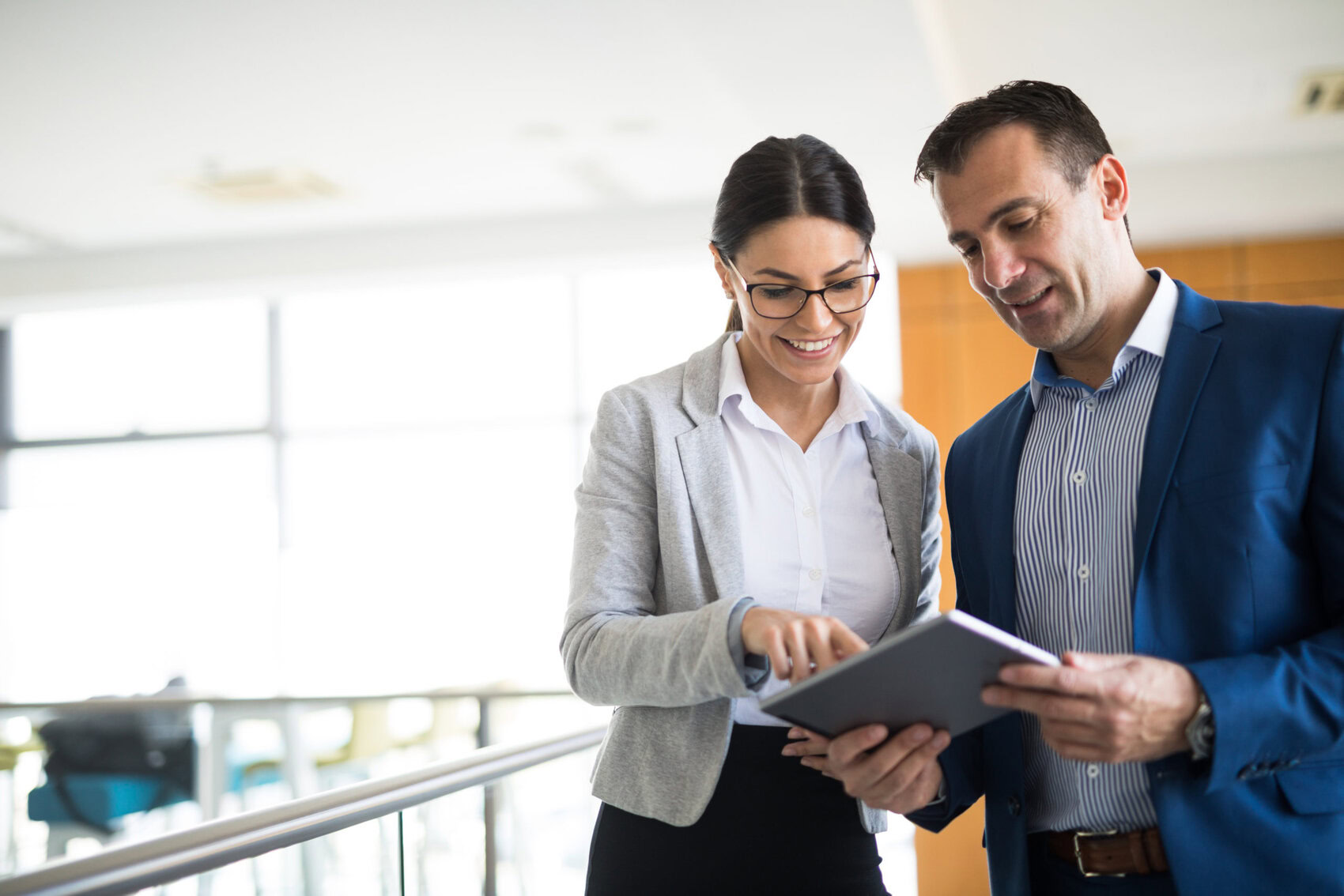 Two business people discussing business strategy using digital tablet Business Professionals