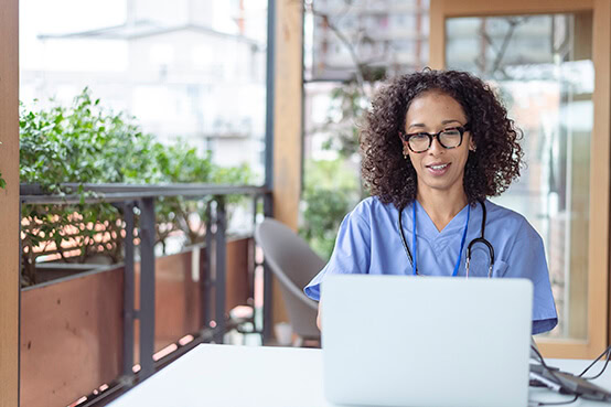 Nurse sitting with laptop